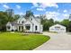 White farmhouse with attached three-car garage and spacious driveway at 5811 Kristi Ln, Midland, NC 28107