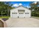 Attached three-car garage with white exterior and spacious parking area at 5811 Kristi Ln, Midland, NC 28107