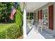 Covered porch with rocking chairs and American flag at 9372 Island Point Rd, Sherrills Ford, NC 28673