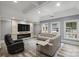 Finished basement with comfortable seating, fireplace, and large TV at 8516 Mcilwaine Rd, Huntersville, NC 28078