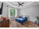 Bright bedroom featuring hardwood floors and a ceiling fan at 8516 Mcilwaine Rd, Huntersville, NC 28078