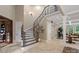 Grand entryway with a curved staircase and tile flooring at 8516 Mcilwaine Rd, Huntersville, NC 28078