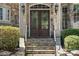 Ornate double front doors with stone steps and landscaping at 8516 Mcilwaine Rd, Huntersville, NC 28078