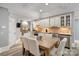 Basement kitchen with white cabinets, granite countertops, and breakfast table at 8516 Mcilwaine Rd, Huntersville, NC 28078