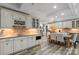 Basement kitchen with white cabinets, granite countertops, and breakfast table at 8516 Mcilwaine Rd, Huntersville, NC 28078