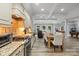 Open concept kitchen features stainless steel appliances and breakfast bar at 8516 Mcilwaine Rd, Huntersville, NC 28078