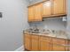 Laundry room with light wood cabinets, granite countertops, and a utility sink at 8516 Mcilwaine Rd, Huntersville, NC 28078