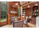 Home office with built-in bookshelves and a fireplace at 8516 Mcilwaine Rd, Huntersville, NC 28078