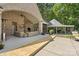 Covered patio with fireplace, comfortable seating, and outdoor kitchen at 8516 Mcilwaine Rd, Huntersville, NC 28078
