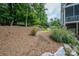 Landscaped backyard with a dry creek bed and mulch at 2593 Cozy Cove Dr, York, SC 29745