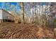 Yard with leaf covered ground and wooded backdrop at 850 Mereva Rd, Smyrna, SC 29743