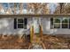 Front view of gray house with black shutters and wooden steps at 850 Mereva Rd, Smyrna, SC 29743