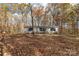 Single-story home with gray siding, surrounded by autumn trees at 850 Mereva Rd, Smyrna, SC 29743