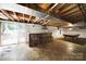 Unfinished basement with exposed ceiling, walkout access, bar and vintage pool table at 9143 Sadlers Ridge Rd, Fort Mill, SC 29707