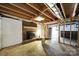 Unfinished basement featuring exposed wood beams, brick fireplace and white painted concrete block at 9143 Sadlers Ridge Rd, Fort Mill, SC 29707
