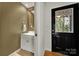 Entryway featuring a bathroom with a mirror and white sink at 9143 Sadlers Ridge Rd, Fort Mill, SC 29707