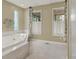 Bright bathroom with a relaxing soaking tub and tile floors at 9143 Sadlers Ridge Rd, Fort Mill, SC 29707