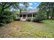 Quaint front porch with brick accents, white railing and porch that extends across the front of the house at 9143 Sadlers Ridge Rd, Fort Mill, SC 29707