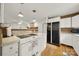 Bright kitchen featuring a tiled backsplash, white cabinets, and a black refrigerator at 9143 Sadlers Ridge Rd, Fort Mill, SC 29707