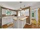 Eat-in kitchen with white cabinets and breakfast bar featuring stylish pendant lights at 9143 Sadlers Ridge Rd, Fort Mill, SC 29707