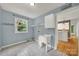 Laundry room features a utility sink, shelving, and tile floor, plus a view to the kitchen at 9143 Sadlers Ridge Rd, Fort Mill, SC 29707