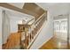 Interior view of hardwood staircase leading to a living room with brick fireplace at 9143 Sadlers Ridge Rd, Fort Mill, SC 29707