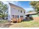 Exterior shot of the deck and backyard with a blue home at 3230 Rogers St, Charlotte, NC 28208
