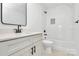 Clean bathroom with a white vanity, tub, and tile floor at 3230 Rogers St, Charlotte, NC 28208