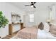Neutral primary bedroom featuring a ceiling fan, wood floors, and console table at 3230 Rogers St, Charlotte, NC 28208