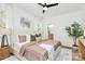 Cozy bedroom with ceiling fan, decorative accents, and adjoining bathroom at 3230 Rogers St, Charlotte, NC 28208
