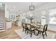 Elegant dining area merges seamlessly with a modern kitchen, featuring a stylish table setting and abundant natural light at 3230 Rogers St, Charlotte, NC 28208