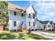 Charming two-story home featuring vertical siding, complemented by a well-manicured front yard and inviting entryway at 3230 Rogers St, Charlotte, NC 28208