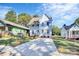 Attractive exterior showcasing light blue siding, a spacious driveway, and well-kept landscaping, blending charm and functionality at 3230 Rogers St, Charlotte, NC 28208