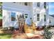 Inviting front entrance with a white door, wooden steps, and manicured landscaping enhancing the home's appeal at 3230 Rogers St, Charlotte, NC 28208