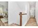 Upstairs hallway with hardwood floors leading to the primary bedroom at 3230 Rogers St, Charlotte, NC 28208
