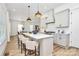 Open kitchen featuring island with seating, modern appliances, and seamless flow to dining area at 3230 Rogers St, Charlotte, NC 28208