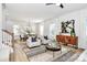 Sunlit living room with wood floors, features modern decor, and a dining area, creating an inviting and stylish atmosphere at 3230 Rogers St, Charlotte, NC 28208