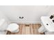 Modern powder room with pedestal sink, new toilet, and wood-look flooring at 3230 Rogers St, Charlotte, NC 28208