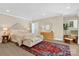 Spacious bedroom with a large bed, ample lighting, and a cozy sitting area at 104 Hidden Cove Dr, Shelby, NC 28150