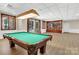 Basement game room with pool table, built-in shelving, and access to backyard at 104 Hidden Cove Dr, Shelby, NC 28150