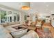 Open living room and kitchen with hardwood floors and access to backyard patio at 104 Hidden Cove Dr, Shelby, NC 28150