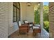 Relaxing covered porch with wicker chairs and ottoman at 104 Hidden Cove Dr, Shelby, NC 28150