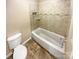 Bathroom featuring a toilet, tilework and tub at 6003 Heath Valley Rd, Charlotte, NC 28210