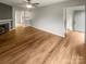 Spacious living room featuring fireplace, fan, and seamless flow into the kitchen at 6003 Heath Valley Rd, Charlotte, NC 28210
