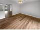 Open-concept living room featuring hardwood flooring and bright, neutral walls at 6003 Heath Valley Rd, Charlotte, NC 28210