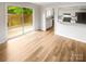 Living room with sliding glass door to patio, and a view into the kitchen at 6003 Heath Valley Rd, Charlotte, NC 28210