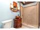 Bathroom with walk-in shower, wood vanity and stained glass window at 903 W Franklin St, Monroe, NC 28112