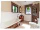 Bathroom with clawfoot tub, wood vanity, vessel sink, and wood details at 903 W Franklin St, Monroe, NC 28112