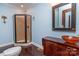 Bathroom with shower, wood vanity, vessel sink, and dark wood floors at 903 W Franklin St, Monroe, NC 28112