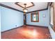 Light blue bedroom with hardwood floors and stained glass window at 903 W Franklin St, Monroe, NC 28112